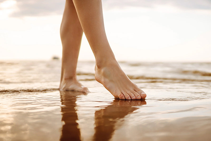 A woman's feet on a pool of water